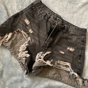 Black distressed cut off shorts.